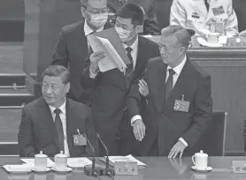  ?? KEVIN FRAYER/GETTY IMAGES ?? Chinese President Xi Jinping, left, looks away as former President Hu Jintao, right, speaks to him as he is removed from the closing session of the 20th National Congress of the Communist Party of China in October 2022. Rumors have spread that the party is operating “sleeper cells” of undercover agents in the U.S., but PolitiFact did not find evidence to back up those claims.