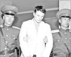  ?? — Reuters photo ?? File photo showa Otto (centre) being taken to North Korea’s top court in Pyongyang, North Korea.
