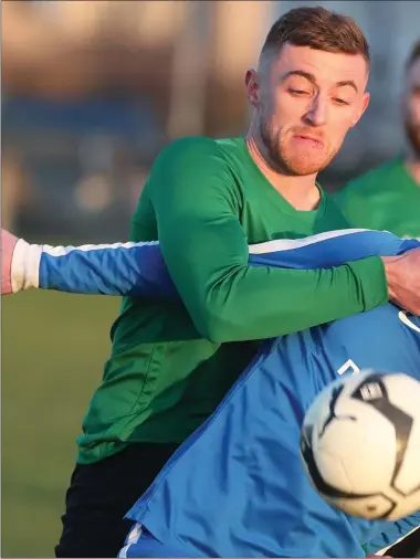  ??  ?? Square United’s Brian Commons battles with Enfield’s Cian O’Hare during Sunday’s Division 1 match at Ardee Comm