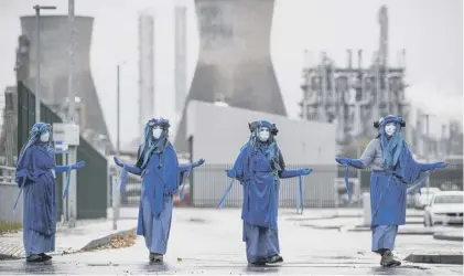 ??  ?? Extinction Rebellion Scotland blocked the road outside the Ineos oil refinery at Grangemout­h yesterday – as other members of the protest group blockaded the plant in boats on the Forth
