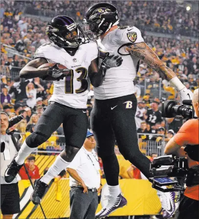  ?? Don Wright ?? The Associated Press Ravens wide receiver John Brown (13) celebrates with tight end Maxx Williams after Brown’s 33-yard touchdown reception in the first half of Baltimore’s 26-14 victory over the Steelers on Sunday in Pittsburgh.