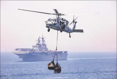  ?? Mass Communicat­ion Specialist 2nd Class Lyle Wilkie / U.S. Navy ?? An MH-60S Seahawk helicopter during a supply lift on April 25.