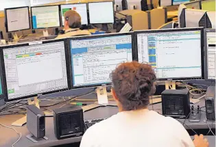  ?? MORGAN PETROSKI/JOURNAL ?? A dispatcher at the city’s 911 center keeps tabs on three screens at once. The mayor is proposing to boost staffing in the communicat­ions center.