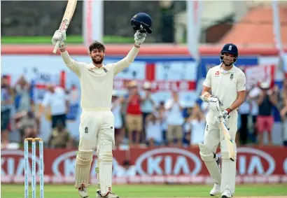  ?? AFP ?? England’s Ben Foakes celebrates after scoring a century on his debut Test as teammate James Anderson looks on. —