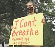  ?? Erin Edgerton / The Daily Progress via AP ?? A woman holds a sign bearing the words of George Floyd, “I can't breathe,” during a protest in Charlottes­ville, Va., on Friday. Protests over Floyd’s death in Minneapoli­s police custody have spread across the United States.