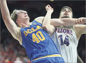  ?? Ralph Freso / AP ?? UCLA’s Thomas Welsh (left) and Arizona’s Dusan Ristic go up for a rebound during a game earlier this season.