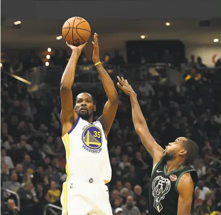  ?? Stacy Revere/Getty Images) / Stacy Revere/Getty Images) ?? The Warriors’ Kevin Durant (35), shooting over Khris Middleton of the Bucks, had 11 points, eight rebounds and six assists.