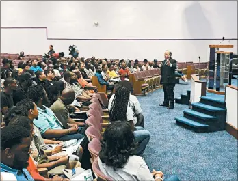  ?? COREY WILLIAMS/AP ?? Mayor Mike Duggan speaks with Detroit residents during a job event where they registered to apply for jobs at a Fiat Chrysler assembly plant.