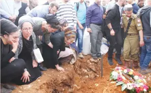  ??  ?? FAMILY MEMBERS mourn Itamar Ben-Gal at his grave yesterday.