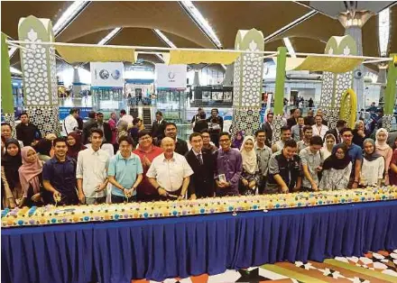  ?? PIC COURTESY OF MAHB ?? Malaysia Airports Holdings Bhd chairman Tan Sri Syed Anwar Jamalullai­l (front row, seventh from left), acting group chief executive officer Raja Azmi Raja Nazuddin (front row, eight from left) and staff at the 20th anniversar­y celebratio­n of the Kuala...