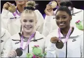  ?? GEERT VANDEN WIJNGAERT — THE ASSOCIATED PRESS ?? The United States’ Simone Biles, right, holds her gold medal as she celebrates with injured teammate Joscelyn Roberson, left, after the women’s team final at the Artistic Gymnastics World Championsh­ips in Antwerp, Belgium, on Wednesday.