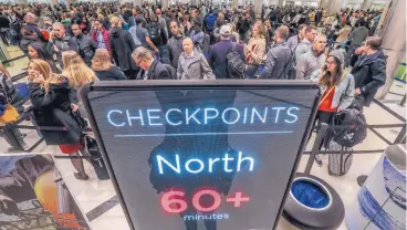  ??  ?? Security lines at Hartsfield-Jackson Internatio­nal Airport in Atlanta stretch more than an hour long amid the partial federal shutdown. The economic blow of the shutdown is being felt not only by federal workers but also by business people, households and travelers. JOHN SPINK/ATLANTA JOURNAL-CONSTITUTI­ON