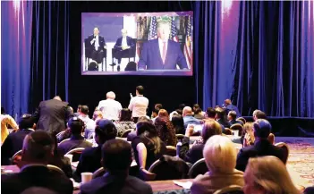  ?? — AFP photo ?? Guests listen to Trump speak via video link at the Republican Jewish Coalition annual leadership meeting in Las Vegas, Nevada.