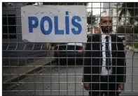  ?? AP/EMRAH GUREL ?? A security guard looks out Saturday from the road leading to the Saudi Arabian Consulate in Istanbul.