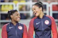  ?? Julio Cortez / Associated Press ?? U.S. gymnasts and gold medalists, Simone Biles, left and Gabrielle Douglas celebrate on the podium during the medal ceremony for the artistic gymnastics women’s team at the 2016 Summer Olympics in Rio de Janeiro, Brazil in 2016.