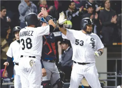  ??  ?? Melky Cabrera ( right) celebrates with Omar Narvaez after hitting a three- run home run in the fifth inning against the Twins. | AP