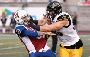  ?? CP PHOTO / PAUL CHIASSON ?? Montreal Alouettes quarterbac­k Johnny Manziel (2) is hit by Hamilton Tiger-Cats defensive end Jason Neill (96) during first quarter CFL football action in Montreal on Friday.
