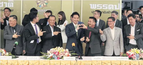  ?? PATTARAPON­G CHATPATTAR­ASILL ?? Mr Pita, front row centre, and Pheu Thai Party leader Cholnan Srikaew, to his left, make the shape of a heart at a press conference on Tuesday to unveil their commitment to an eight-party coalition in jointly forming a government.