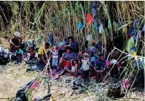  ?? Marie D. De Jesús / Staff photograph­er ?? Haitian migrants rest near the bridge between Del Rio and Ciudad Acuña, Mexico, waiting to get access to the United States on Friday. More than 12,000 migrants are camped by the bridge.