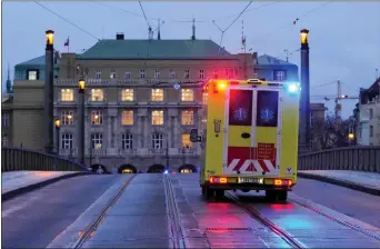  ?? PETR DAVID JOSEK - THE ASSOCIATED PRESS ?? An ambulance drives toward the building of Philosophi­cal Faculty of Charles University in downtown Prague on Thursday. Czech police say a shooting killed more than a dozen people.