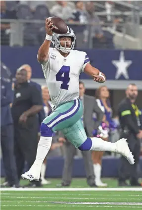  ?? MATTHEW EMMONS/USA TODAY ?? The Cowboys’ Dak Prescott fakes a pass while on the run Sunday. He rushed for 82 yards and 1 TD and threw for 183 yards and 2 TDs.
