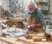  ?? JILLIAN LYNCH/AP ?? Roman Miller picks out a blade for a scroll saw in the wood shop at the Virginia Mennonite Retirement Community in Harrisonbu­rg.