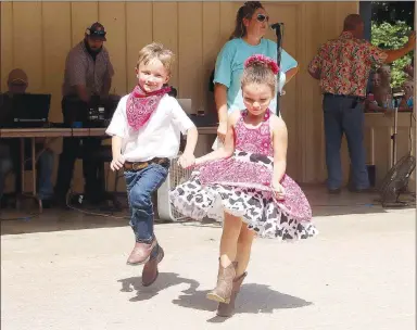  ?? FILE PHOTO ?? Isabella Contreras and Channing Hunt with Buckles-N-Belles square dance group dance at the 2019 Clotheslin­e Fair.