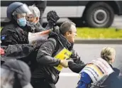  ?? SWEN PFOERTNER AP ?? Police and protesters clashed Saturday during a rally against virus restrictio­ns in Kassel, Germany.