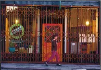  ??  ?? Top right: A pedestrian walks past the Issues magazine and bookstore, now closed, in Oakland. Newsom’s budget proposal includes $575 million in small business grants.