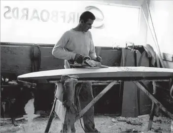  ??  ?? A REVOLUTION IN WAVE RIDING Gordon, here shaping a balsa wood surf board in 1960, founded Gordon & Smith Surf boards & Skateboard­s
with Floyd Smith in the late 1950s. Their polyuretha­ne foam boards made surfing more accessible.