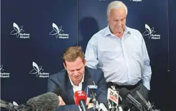  ?? AP ?? ■ Steve Smith breaks down as he speaks to the media while being supported by his father Peter in Sydney on Thursday after being sent home from South Africa following a ball tampering scandal.