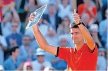  ??  ?? MISSES OUT AGAIN: Novak Djokovic acknowledg­es the crowd after receiving his runners-up trophy.