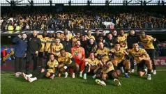  ?? Photo: AFP ?? Maidstone players and staff celebrate in front of their fans after their historic win.