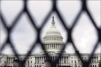  ?? Brynn Anderson / Associated Press ?? Security fencing is seen around the Capitol in Washington on Friday, ahead of a weekend rally planned by allies of former President Donald Trump that is aimed at supporting the so-called “political prisoners” of the Jan. 6 insurrecti­on at the U.S. Capitol.