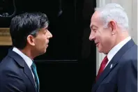  ?? — afp ?? Britain’s Prime Minister Rishi Sunak greets Israel’s Prime Minister Benjamin Netanyahu on the steps of 10 Downing Street in London on Friday ahead of their meeting.