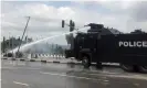  ??  ?? Police use water cannon to disperse protesters in Abuja on Sunday. Photograph: Abraham Achirga/Reuters