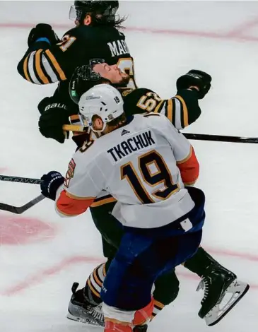  ?? MATTHew J. lee/Globe STAff ?? Matthew Tkachuk wasted no time welcoming Andrew Peeke back after the defenseman returned from a seven-game absence.