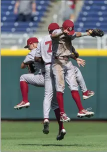  ?? JOHN PETERSON — THE ASSOCIATED PRESS ?? Oklahoma outfielder­s Tanner Tredaway, left, Kendall Pettis (7) and John Spikerman celebrate a win over Texas A&M last week.