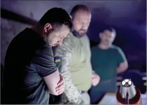  ?? The Associated Press ?? Ukrainian President Volodymyr Zelenskyy, left, listens to a servicemen report close to front line in Donetsk region, Ukraine, Sunday.