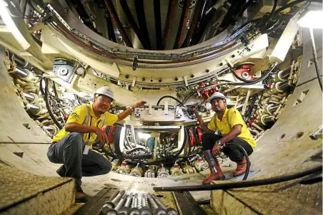  ??  ?? Tunnel manager Mazuki Salleh (left) and alvin George Francis (right) inside a TBM. Francis, 28, is of the opinion that the company puts a lot of hope on young talents. ‘Priority is given to the young, and we have been given a good platform to prove...