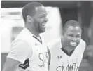  ?? ALGERINA PERNA/BALTIMORE SUN ?? Former Terps basketball star Sean Mosley, left, jokes with the host during the seventh annual Torrey Smith Family Fund charity Basketball Game.