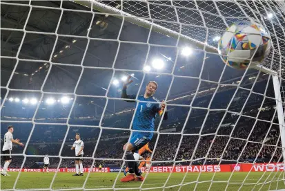  ??  ?? Netherland­s’ defender Virgil van Dijk (second right) scores past Germany goalkeeper Manuel Neuer in the last minute to secure a 2-2 draw in their UEFA Nations League match in Gelsenkirc­hen, Germany, on Monday. The Dutch scored twice in the last 5 minutes, including a Quincy Promes strike, to seal the draw which secured them a spot in next year’s final ahead of world champion France. Switzerlan­d, England and hosts Portugal had already qualified for the four-team final in June. — AFP