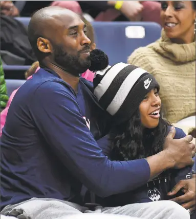  ?? Jessica Hill / Associated Press ?? Kobe Bryant and his daughter Gianna watch the first half between UConn and Houston at Gampel Pavilion on Saturday in Storrs.