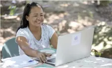  ?? ?? Tikuna’s Indigenous woman Cristina Quirino Mariano writes a message using the app Linklado in Manaus, Amazonas State, northern Brazil.