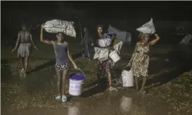  ?? Photograph: Joseph Odelyn/AP ?? Already traumatise­d by an earthquake, Haitians brave Tropical Storm Grace at a refugee camp in Les Cayes last week.