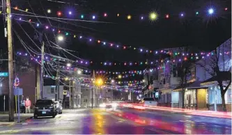  ?? CHARLES KRUPA AP ?? Car taillights streak under Christmas lights recently turned back on in Farmington, N.H. As the coronaviru­s spreads, holiday lights are going back up to provide a bit of emotional and actual brightness.