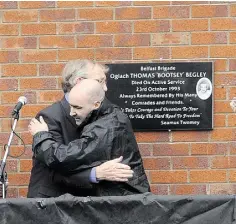  ??  ?? COMMON BOND: Left, hundreds attend a service in West Kirk to mark the 20th anniversar­y of the Shankill bombing; above, Shankill bomber Sean Kelly comforts the father of fellow bomber Thomas Begley during a memorial ceremony and the unveiling of a...