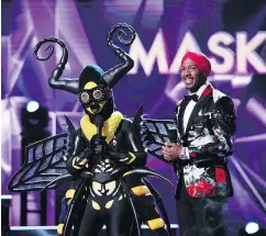  ??  ?? Bee, left, and host Nick Cannon in the episode Semi Finals: Double Unmasking.