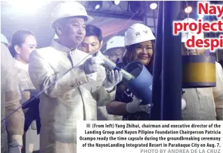  ?? PHOTO BY ANDREA DE LA CRUZ ?? ( From left) Yang Zhihui, chairman and executive director of the Landing Group and Nayon Pilipino Foundation Chairperso­n Patricia Ocampo ready the time capsule during the groundbrea­king ceremony of the NayonLandi­ng Integrated Resort in Parañaque City on Aug. 7.