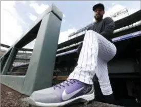  ?? DAVID ZALUBOWSKI — THE ASSOCIATED PRESS ?? Colorado Rockies rookie starting pitcher Antonio Senzatela shows the inscriptio­n on his shoes to his mother, Nidya, in Denver. Nidya never got to see her son pitch in the majors, passing away last July of cancer.